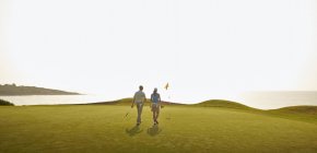 Kaukasisches Paar spielt Golf auf Golfplatz — Stockfoto
