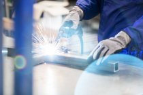 Welder welding steel in factory — Stock Photo