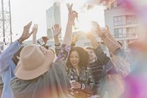 Young adults dancing at rooftop party — Stock Photo