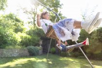 Carefree girls swinging in backyard — Stock Photo