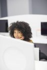 Donna d'affari sorridente alla scrivania in ufficio moderno — Foto stock