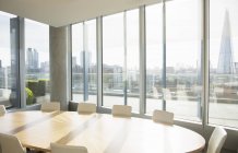 Empty conference room overlooking city — Stock Photo