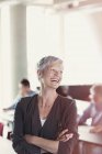 Laughing senior woman in adult education classroom — Stock Photo