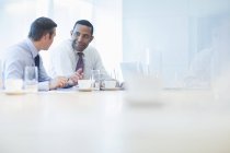 Businessmen talking in conference room — Stock Photo