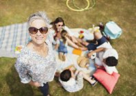Retrato sonriente mujer mayor con familia en el picnic - foto de stock