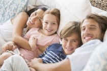 Family relaxing together on sofa — Stock Photo