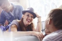 Smiling woman getting a back tattoo at studio — Stock Photo