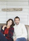 Portrait smiling couple on porch below ?The Shack? sign — Stock Photo