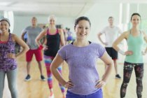Portrait smiling exercise class with hands on hips in studio — Stock Photo