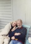 Portrait smiling senior couple hugging on patio — Stock Photo