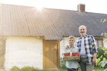 Portrait proud grandfather and grandson with harvested strawberries — Stock Photo