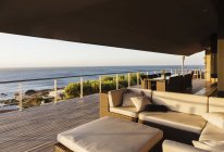 Sofa and table on luxury patio overlooking ocean — Stock Photo