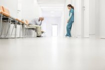 Stressed doctor and nurse in hospital corridor — Stock Photo