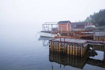 Boathouses and dock on bay — Stock Photo