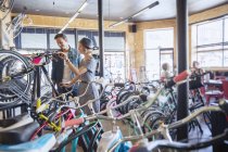 Couple browsing bicycles on rack in bicycle shop — Stock Photo