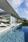 Scenic view of patio and pool along modern house — Stock Photo