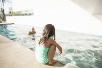 Petite fille au bord de la piscine — Photo de stock