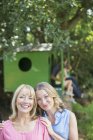 Mother and adult daughter smiling outdoors — Stock Photo