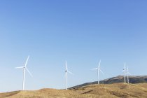 Wind turbines spinning in rural landscape — Stock Photo