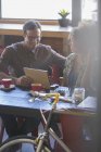 Друзі діляться цифровим планшетом у кафе — стокове фото