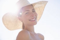 Young attractive woman wearing sun hat outdoors — Stock Photo