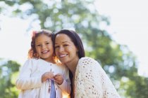 Portrait smiling mother and daughter outdoors — Stock Photo