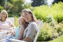 Multi-generation women laughing in backyard — Stock Photo