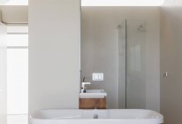Bathtub, shower and sink in modern bathroom interior — Stock Photo