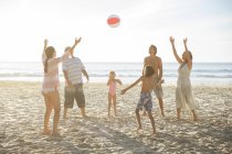 Família brincando juntos na praia — Fotografia de Stock