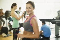 Portrait smiling woman resting at gym — Stock Photo
