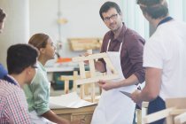 Teacher and students in adult education carpentry workshop class — Stock Photo