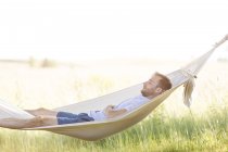 Young man sleeping in summer hammock — Stock Photo