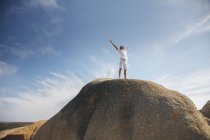 Man standing on top of rock formation — Stock Photo