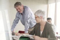 Students discussing homework in adult education classroom — Stock Photo
