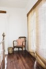 Reed curtains and armchair in bedroom — Stock Photo