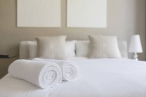 White towels on bed in bedroom interior — Stock Photo