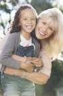 Portrait smiling grandmother and granddaughter hugging — Stock Photo