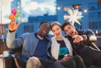 Portrait enthusiastic friends enjoying rooftop party — Stock Photo