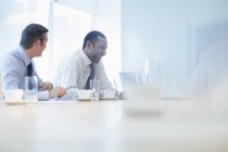 Businessmen talking in meeting indoors — Stock Photo