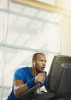 Determined man on elliptical trainer at gym — Stock Photo