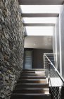 Stairs and stone wall in modern house — Stock Photo