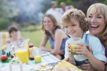Familia feliz comer juntos al aire libre - foto de stock