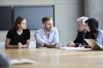 Empresários discutindo papelada em reunião — Fotografia de Stock