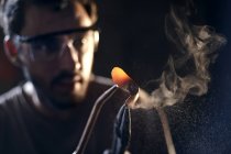 Close up of blacksmith shaping iron with blowtorch — Stock Photo