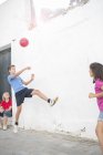 Children playing with soccer ball in alley — Stock Photo