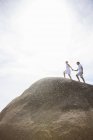 Couple walking on rock formation — Stock Photo