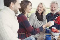 Couples drinking coffee on patio — Stock Photo