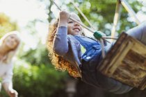 Carefree girl swinging in park — Stock Photo