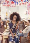 Portrait enthusiastic woman with afro in cafe — Stock Photo
