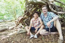 Portrait smiling father and son in woods — Stock Photo